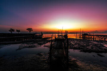 The natural background of the morning light by the sea, the local fishing pier in Ban Tha Sala, Nakhon Si Thammarat, has the beauty of the golden light of the sun.