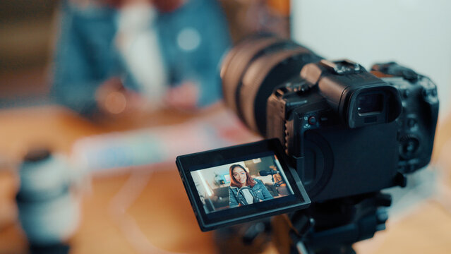 Woman, influencer and video camera with screen for recording, online streaming or live tutorial. Female person, videographer or designer with headphones for audio podcast, review or content creation