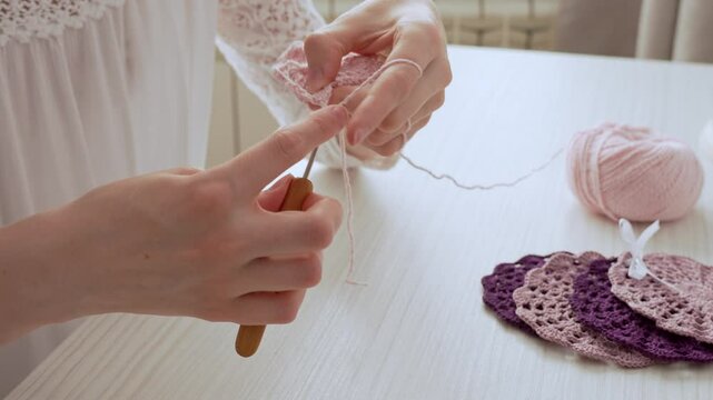 Timeless craft of crochet. Women's hands crocheting an openwork product