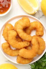 Tasty tempura shrimps served on white marble table, flat lay