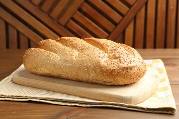 One fresh bread loaf on wooden table