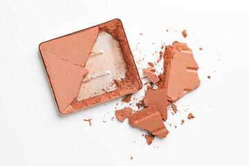 Broken eyeshadow refill pan on white background, top view