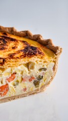 A rich and savory slice of quiche displayed on a smooth white backdrop – quiche wallpaper – bakery wallpaper – quiche image

