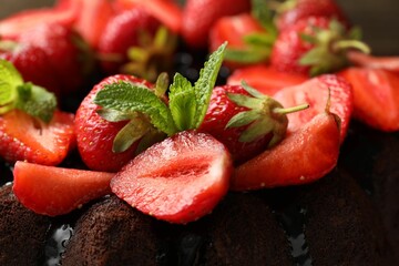 Delicious chocolate bundt cake with strawberries and mint, closeup