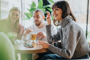 Three friends share a moment at a cafe, enjoying drinks and warm conversation during a relaxing gathering.