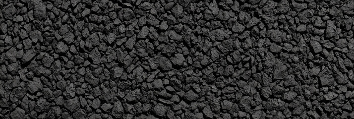 Fototapeta premium Rough black stone gravel texture background perfect for industrial design, construction, dark aesthetics, or minimalist contrast concepts in architectural, digital, or environmental visuals