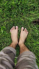 Bare feet on lush green grass