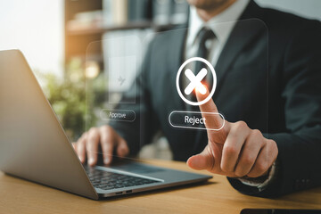 Business hand in gray suit pressing digital reject button above approve option at wooden desk with professional warm lighting

