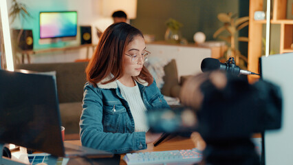 Content creation, camera and woman in studio, mic and communication with influencer. People, house and social media with host, talk show and radio with podcast, connection and film equipment