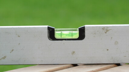 Using a level tool to ensure precision in construction and renovation tasks outdoors