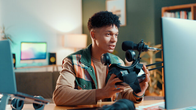 Man, influencer or gamer streaming with vr goggles for online tutorial or guide at home. Male person, freelancer or caster talking with technology or mic for audio podcast, tips or gaming review