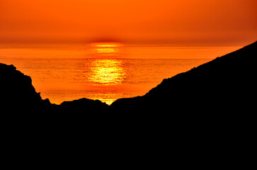 Spectacular sunset with an orange sky on a beach in Asturias, Cantabrian Sea, Spain