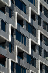 Modern Apartment Building Facade with Geometric Balconies and Shadow Patterns