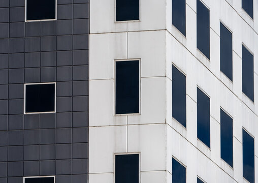 Geometric Building Facade - Contrast Between Black and White Panels with Windows - Powered by Adobe