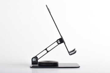 Metal alloy adjustable phone holder. Folding desktop phone stand isolated on white background.