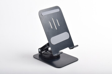 Metal alloy adjustable phone holder. Folding desktop phone stand isolated on white background.