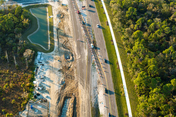 Roadworks construction site on American highway. Development of city transportation crossroads