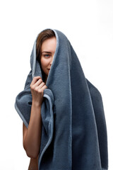 Young woman hiding under a towel