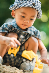 Curious toddler playing with sand outdoors, developing fine motor skills, creativity, and cognitive growth through hands-on exploration in a safe, natural learning environment under sunlight