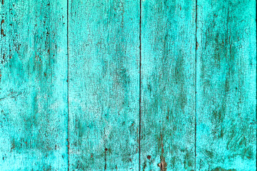 Cracked and weathered turquoise paint on old wooden surface. Perfect rustic background for design projects, websites, posters, and vintage-style artwork.