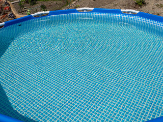 A blue swimming pool with a blue tile floor