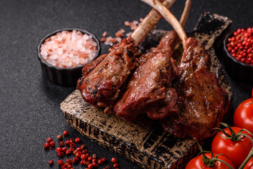Juicy meat on the bone or rack of lamb. Grilled veal with salt, spices and herbs