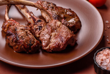Juicy meat on the bone or rack of lamb. Grilled veal with salt, spices and herbs