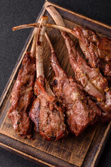 Juicy meat on the bone or rack of lamb. Grilled veal with salt, spices and herbs