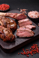 Juicy meat on the bone or rack of lamb. Grilled veal with salt, spices and herbs