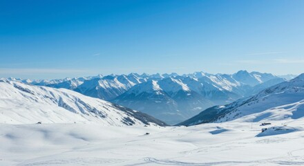 Obraz premium Panoramic view of snow-covered mountains under a clear blue sky. Vast, pristine landscape