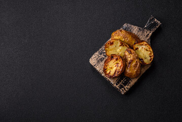Food, potatoes cut in halves or slices grilled. Cooked baked potatoes