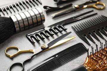 Different hairdresser's tools on grey table, closeup
