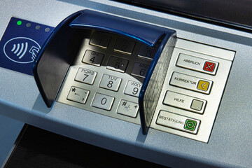 Detail of an ATM keypad and operation buttons used for secure digital transactions in German...