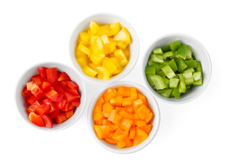 Pieces of fresh colorful bell peppers in bowls isolated on white, top view