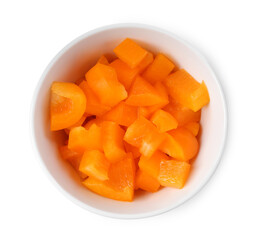 Pieces of fresh orange bell peppers in bowl isolated on white, top view