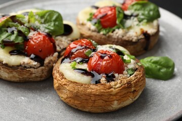 Tasty stuffed mushrooms served on table, closeup