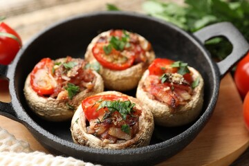 Tasty stuffed mushrooms served on table, closeup