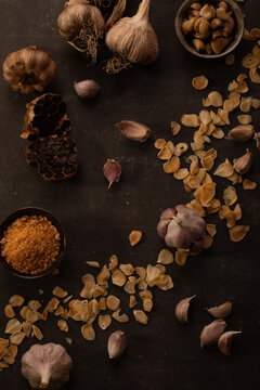 Rustic Garlic Assortment with Flakes and Minced Garlic on Dark Background