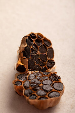 Garlic bulb sliced in half showing cloves on light benchtop