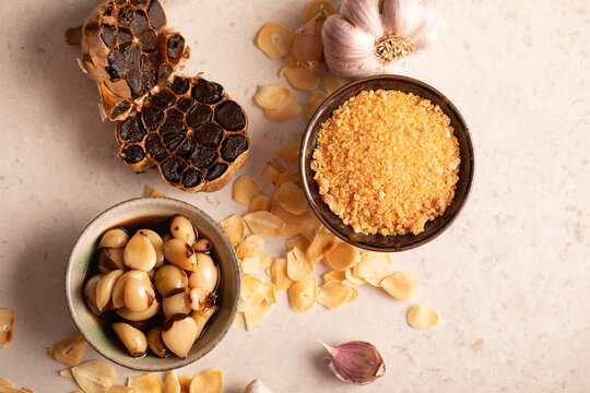 Garlic cloves and bulb and garlic salt in bowl flatlay
