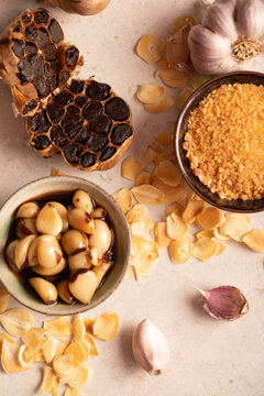 Assorted Garlic Types and Garlic Products on Neutral Background