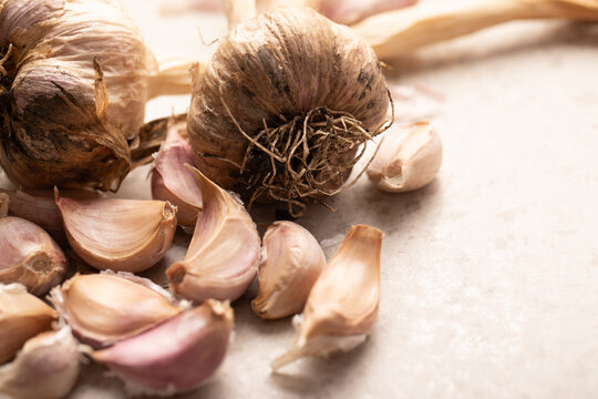 Garlic bulb and cloves on stone benchtop