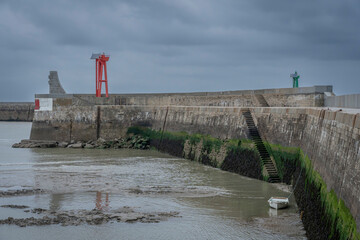 Port-en-Bessin-Huppain, France - 05 15 2025: Graphical view of the harbor, the pier stone...