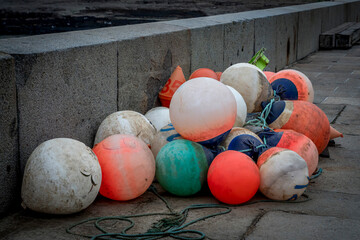 Port-en-Bessin-Huppain, France - 05 15 2025: Graphical view of the Colorful and fluorescent buoys...