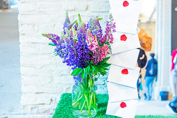 bouquet of lilac and blue lupines with letters sealed with red sealing wax. Holiday and...