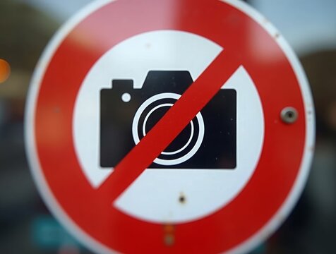 Extreme close-up of a “No Photography” sign with a camera icon and a crossed-out lens