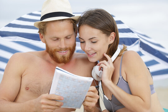 couple reading book and relax on beach