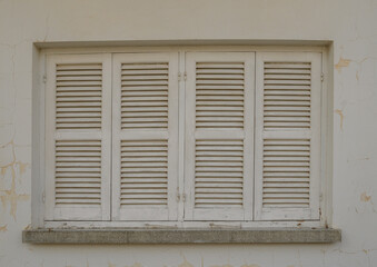 White Window with Wooden Shutters on Traditional Cyprus House