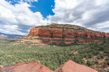 Sedona, Arizona, red rock formations and scenic landscapes under dramatic cloud-filled skies, capturing the natural beauty of the desert wilderness.