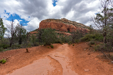 Sedona, Arizona, red rock formations and scenic landscapes under dramatic cloud-filled skies, capturing the natural beauty of the desert wilderness.